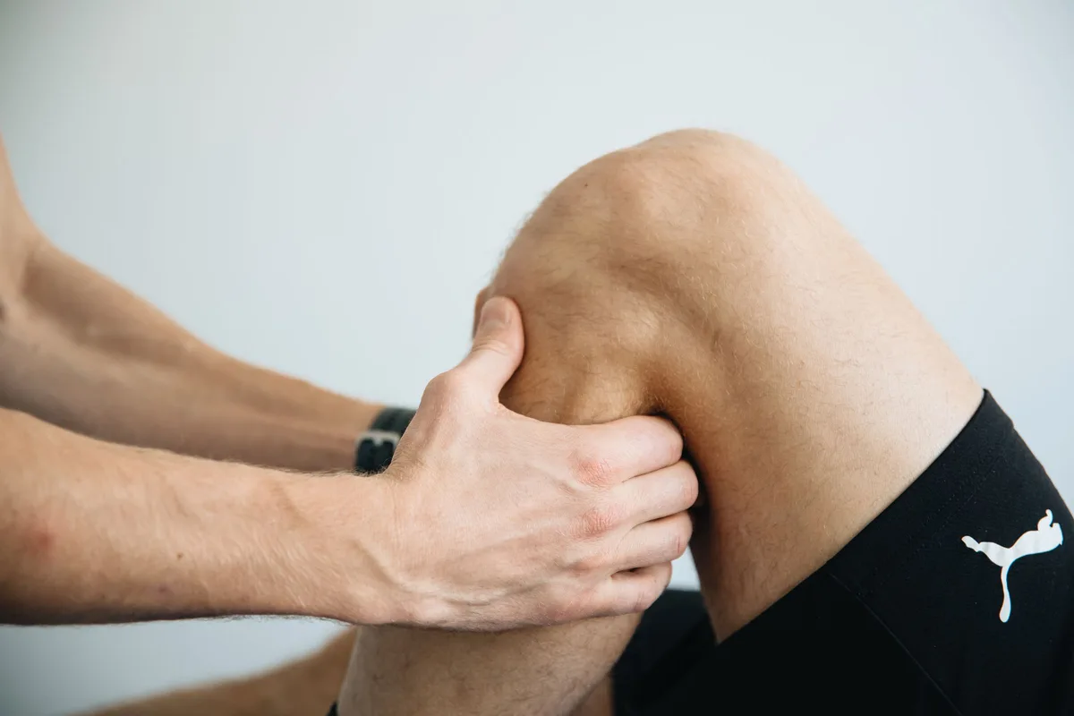 Cold pack applied to a knee during recovery from a soft tissue injury
