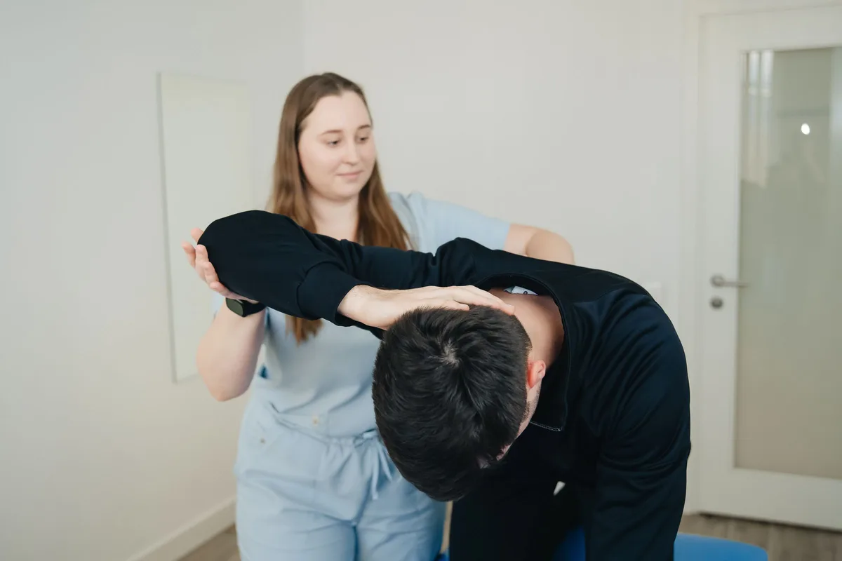 Chiropractor treating a patient's lower back in a Greenville, SC clinic