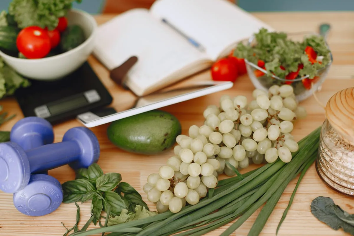 Fresh produce and dumbbells laid out for meal prep