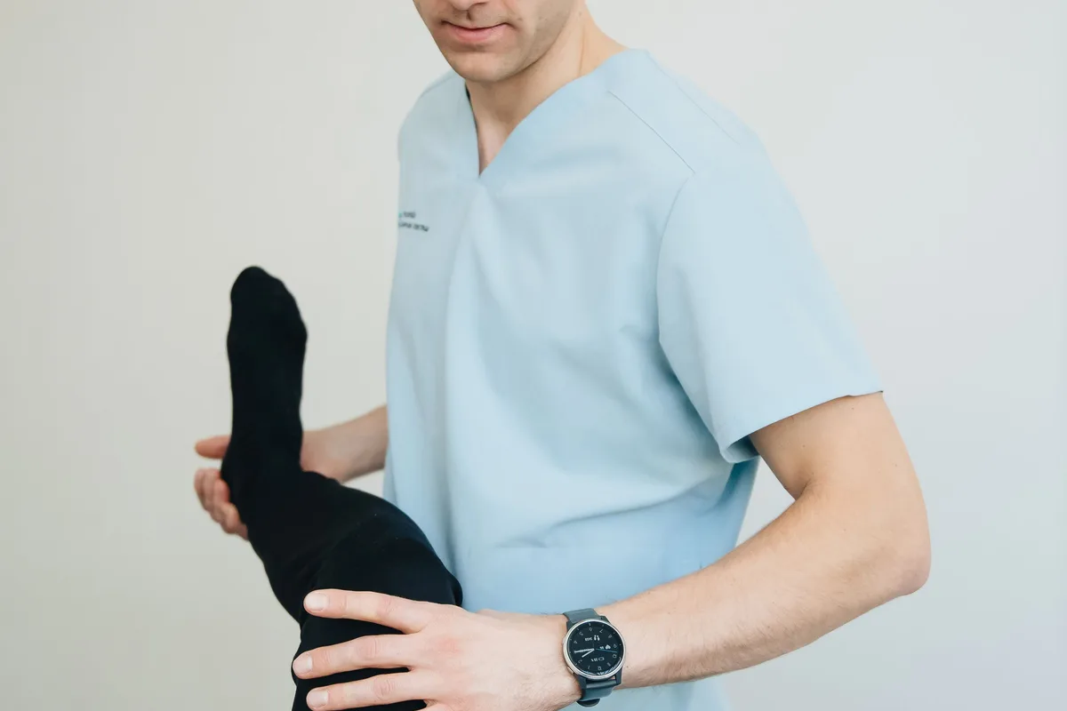 Practitioner-assisted hamstring stretch during a chiropractic session